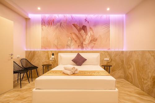 a bedroom with a bed with a painting on the wall at Bed Cinecittadue in Rome