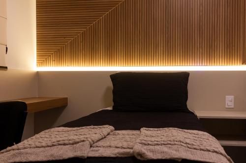Ένα ή περισσότερα κρεβάτια σε δωμάτιο στο Loft Super Aconchegante