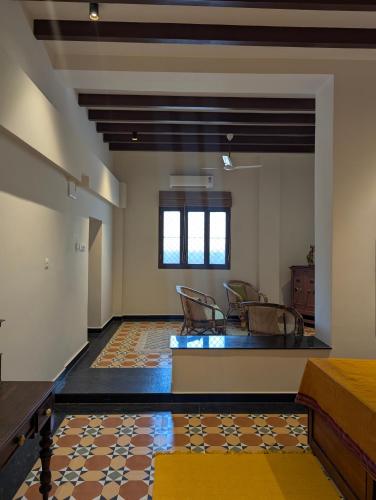 a room with chairs and a table in a building at Nilayam by Luxunlock Private Villas in Jāmb