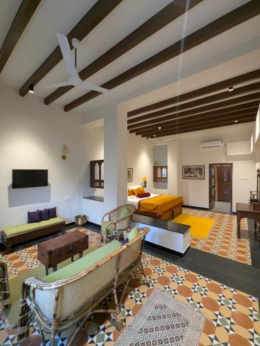 a large living room with couches and a tv at Nilayam by Luxunlock Private Villas in Jāmb