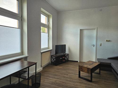 a living room with a couch and a tv at Haus Sonnenschein in Reuterstadt Stavenhagen