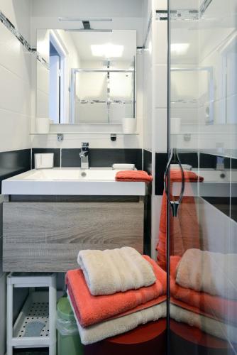 a bathroom with a sink and a mirror at Nice seaside nest with private garden and carpark in Carry-le-Rouet
