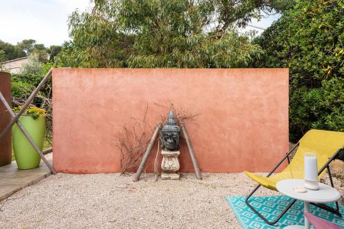 a fire hydrant in front of a wall at Nice seaside nest with private garden and carpark in Carry-le-Rouet
