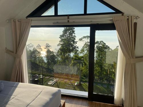 a bedroom with a large window with a view at Alengkong Bali Camp in Kubupenlokan