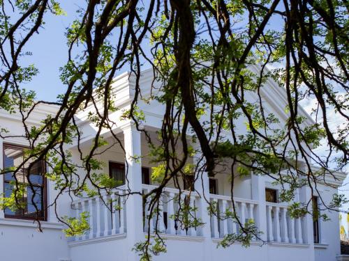 a white building with white columns at The Residence Boutique Hotel in Pineview