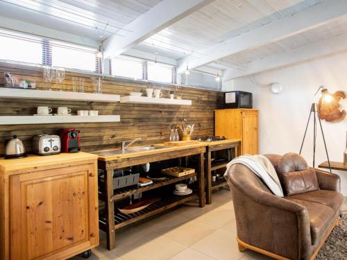 a kitchen with wooden cabinets and a sink and a chair at The Residence Boutique Hotel in Pineview