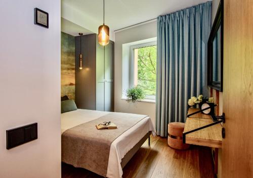 a hotel room with a bed and a window at Premium Seaside Escape with Forest View and Free Parking in Tallinn
