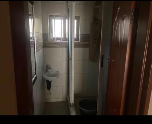 a small bathroom with a toilet and a sink at elon moreh in Lusaka