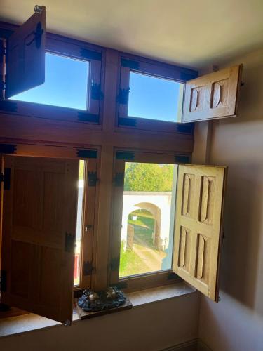 a room with a window and a door at Manoir Du Bois Noblet in Louerre