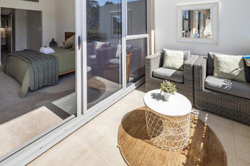 a living room with a couch and a table at Bright & Spacious Penthouse by Parliament House in Barton