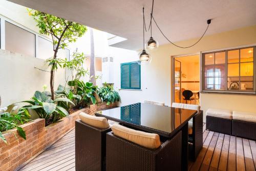 a dining room with a table and some plants at GuestReady - Madeiran paradise with ocean view in Funchal