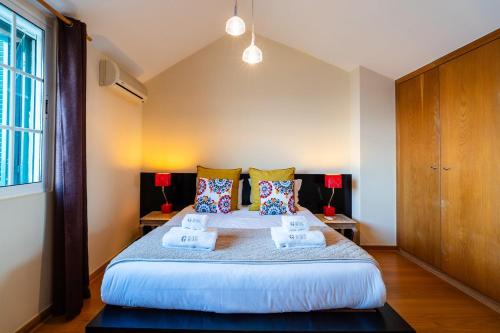 a bedroom with a large bed with two pillows at GuestReady - Madeiran paradise with ocean view in Funchal