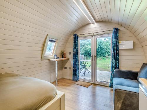a room with a bed and a window in a house at Cow & Plough Stoughton Grange in Oadby