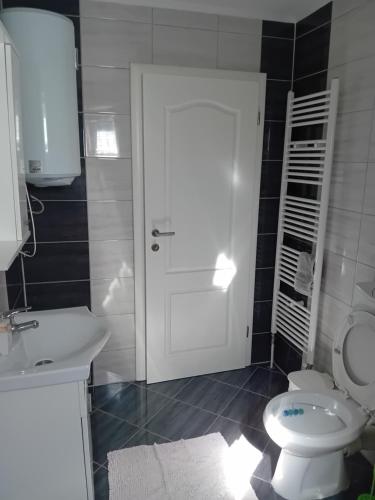 a bathroom with a white toilet and a sink at MEDINA in Sarajevo