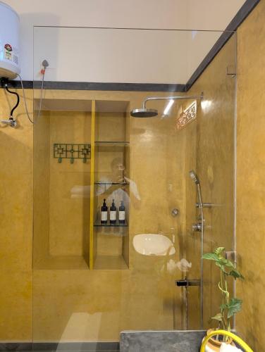 a bathroom with a shower with a sink at Nilayam by Luxunlock Private Villas in Jāmb