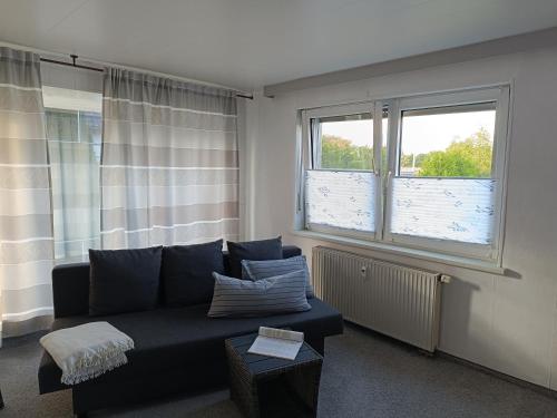 a living room with a couch and a window at Haus Gottschalk Nähe Küchenwelten in Niederdorla