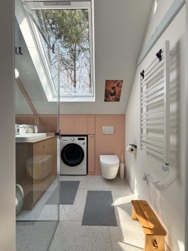 a bathroom with a sink and a washing machine at Kwiat Sosny in Pszczew