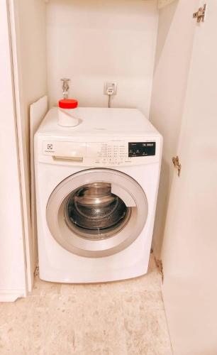a washing machine with a bowl on top of it at Sky Suites KLCC by TD Luxe Global in Kuala Lumpur