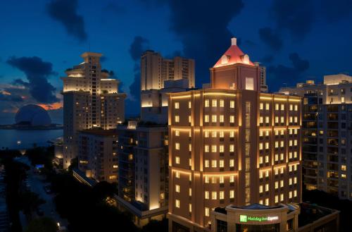 a lit up building in a city at night at Holiday Inn Express Zhuhai Grand Theater by IHG in Zhuhai