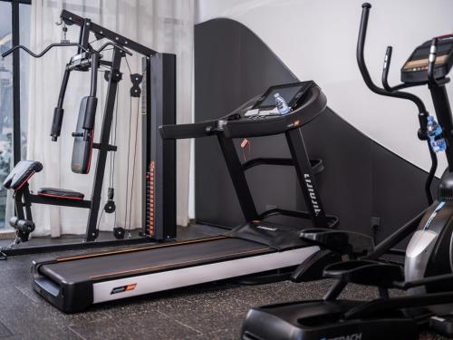 a gym with a treadmill and two exercise bikes at Holiday Inn Express Zhuhai Grand Theater by IHG in Zhuhai
