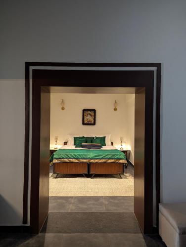 a bedroom with a large bed in a room at Nilayam by Luxunlock Private Villas in Jāmb