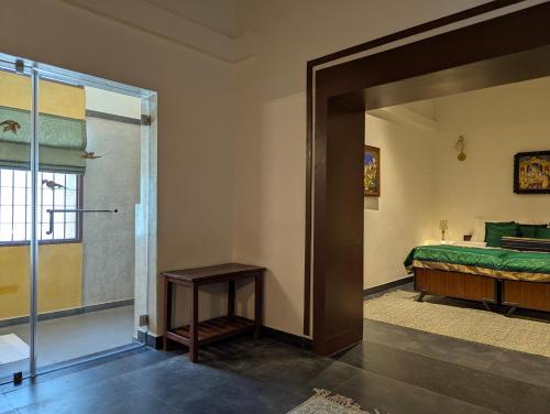 a bedroom with a bed and a sliding glass door at Nilayam by Luxunlock Private Villas in Jāmb