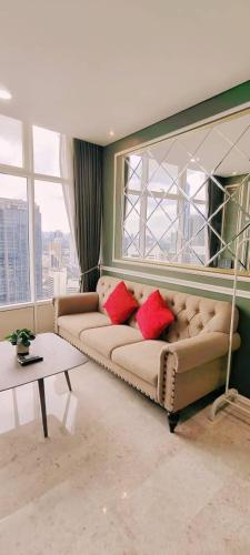a living room with two couches in front of a window at Sky Suites KLCC by TD Luxe Global in Kuala Lumpur
