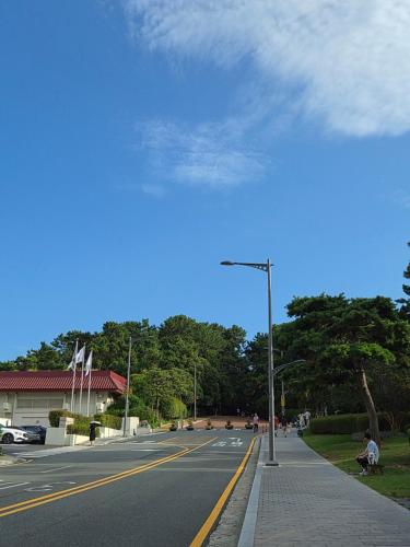 a street with a street light on the side of a road at Haeundae HaeRium Hotel in Busan