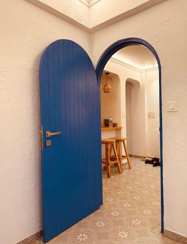 a blue door in a room with a table at Azure Luxury 2Bhk in Candolim