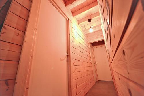 a hallway in a house with wooden walls at Chalet Mandoline in Petit Mesnil
