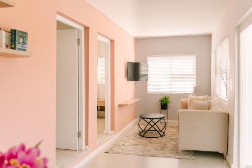 a living room with a chair and a table at The Salene Hotel & Apartments in Stellenbosch