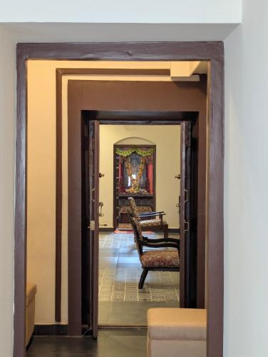 a view of a hallway with a chair in a room at Nilayam by Luxunlock Private Villas in Jāmb