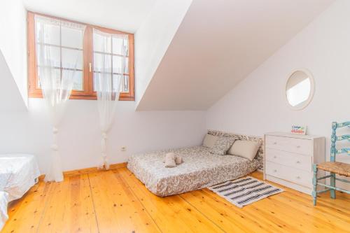 a white living room with a couch and a window at Mountain Escape for Families & Friends in Pyrenees in Fiscal