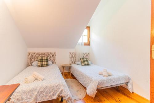 a bedroom with two beds and a window at Mountain Escape for Families & Friends in Pyrenees in Fiscal