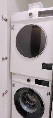 a microwave oven sitting on top of a dryer at Sky Suites KLCC by TD Luxe Global in Kuala Lumpur