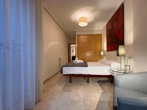 a bedroom with a bed and a couch at Los Amantes de Teruel viven aquí in Teruel