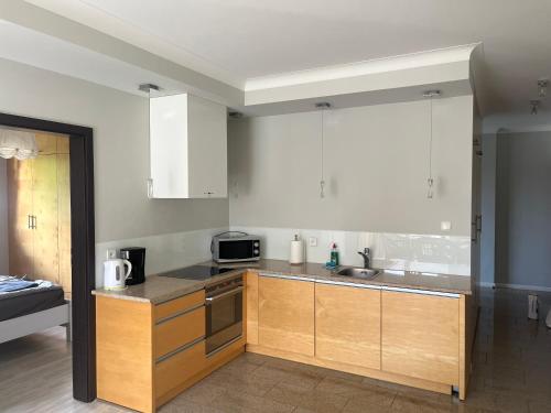 a kitchen with a sink and a microwave at Modern flat close to the beach in Świnoujście