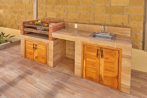 a kitchen with a sink and a counter at City Express Plus by Marriott Cabo San Lucas in Cabo San Lucas