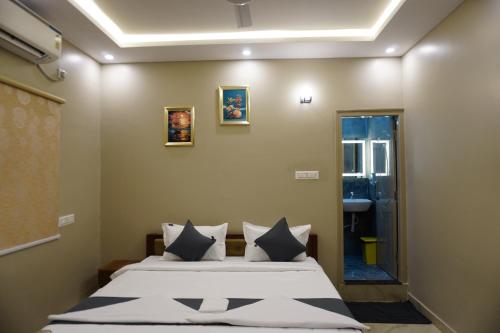 a bedroom with two beds and a mirror at Stazy Suites Kammanahalli in Bengaluru