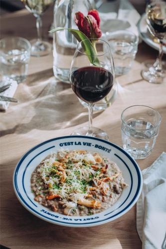 a plate of food on a table with a glass of wine at Radisson Blu Hotel Uppsala in Uppsala