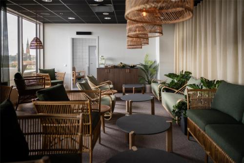 a waiting room with couches and chairs and tables at Radisson Blu Hotel Uppsala in Uppsala
