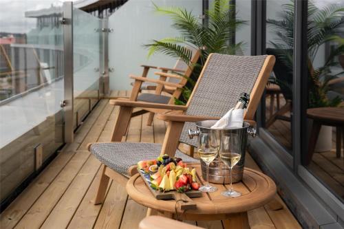 a bottle of wine and a tray of fruit on a balcony at Radisson Blu Hotel Uppsala in Uppsala