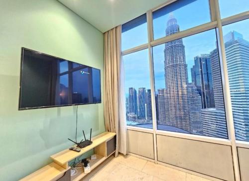 a room with a large window with a large television at Sky Suites KLCC by TD Luxe Global in Kuala Lumpur