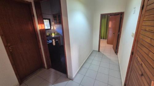 a hallway of a kitchen with a black refrigerator at Faraya Vista in Kfardebian