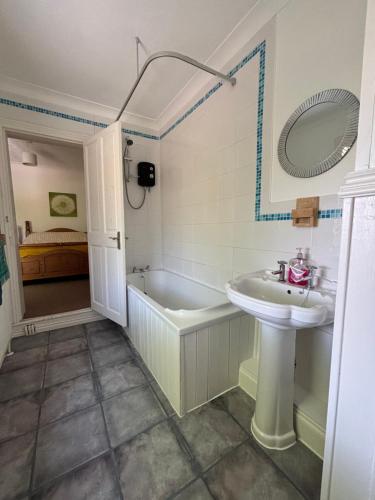 a bathroom with a bath tub and a sink at “The Reach” Lovely 2 bed house in Gorleston on Sea in Gorleston-on-Sea