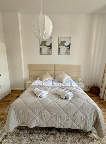 a bedroom with a large bed with two pillows at Apartamenty Śródmiejska in Świebodzin