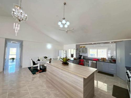 a kitchen with a island in the middle of a room at Toafa Elidad Airport Lodge 