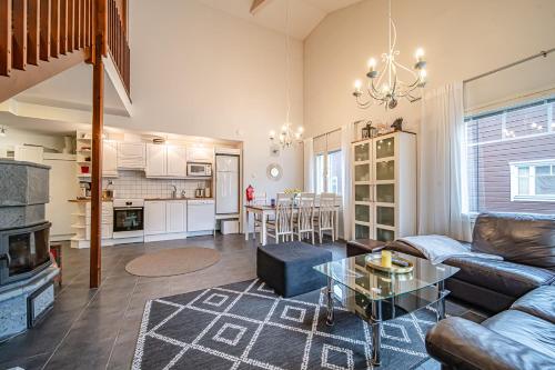 a living room with a couch and a table at Alte Levi Dali by Aavalevi Holidays in Levi