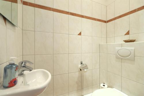 a bathroom with a sink and a toilet at Appartementhaus Strandnähe in Warnemünde