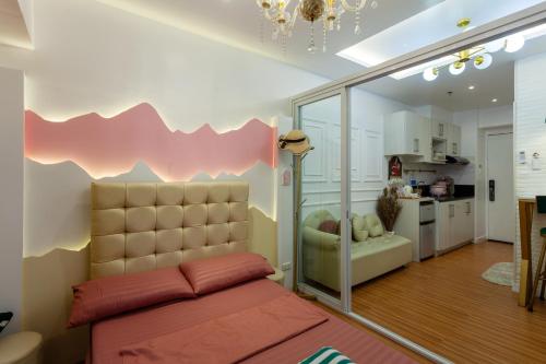 a living room with a bed and a kitchen at Unique Chiq and comfy place with board games, Quezon City in Manila